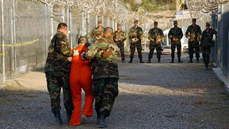 a-guantanamo-prisoner-made-to-walk-on-broken-peeples-5b1e20f1d66ec21e51360149bb84efed1674321714.jpg