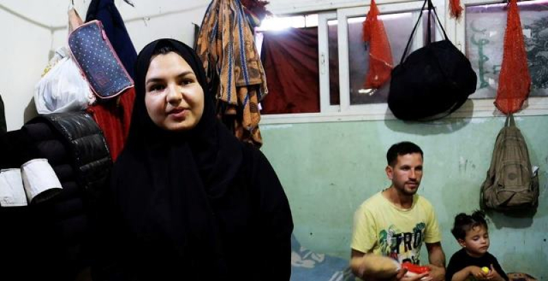 ghalia-al-kilani-with-her-brother-in-law-bassem-al-habal-and-her-niece-in-the-background-in-a-shelter-for-displaced-people-in-deir-al-balah-gaza-1528872e3e44dbd5e2ff2f639f9dda671714225190.jpg